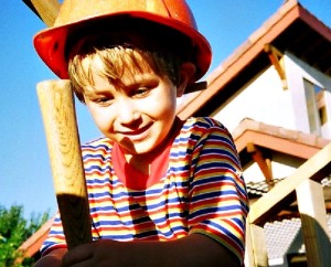 Grow the Can-DO DIY Mindset. Young Dale Stephens in construction hat helping his dad build a playhouse. www.LisaNalbone.com
